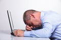 Old business man sleeping on his laptop Royalty Free Stock Photo