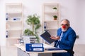 Old businessman clown working in the office Royalty Free Stock Photo