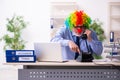 Old businessman clown working in the office Royalty Free Stock Photo