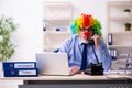 Old businessman clown working in the office Royalty Free Stock Photo