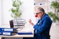 Old businessman clown working in the office Royalty Free Stock Photo