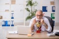 Old male employee being awarded with golden cup Royalty Free Stock Photo