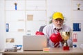 Old male employee boxer being awarded with golden cup