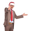 Old businessman wearing santa claus hat presenting and making ok Royalty Free Stock Photo