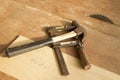 Old c-clamp and hammer on wood