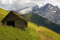 Old cabin in Dolomites with Marmolada peak on the background