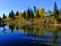 Old Cabin in Forest in Autumn fall by River Water Reflection of Trees Royalty Free Stock Photo