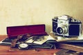 Old camera, antique photographs and old pocket clock Royalty Free Stock Photo