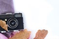 Old camera and autumn leaveson a white background . Royalty Free Stock Photo