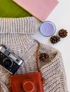 Old camera, books and warm clothes on the table Royalty Free Stock Photo