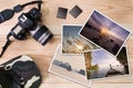 Old camera, cap, memory cards and stack of photos on wooden background Royalty Free Stock Photo