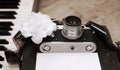 old camera, film, piano, white flower Royalty Free Stock Photo