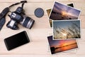 Old camera, smartphone and stack of photos on wooden background