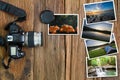 Old camera and stack of photos on vintage grunge wooden background