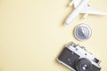 Old camera, toy airplane and compass on yellow background Royalty Free Stock Photo