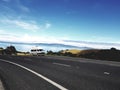 Old campervan parked at a lookout on the road in New Zealand on stunning Coromandel Peninsula with clear blue sky