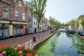 An old canal with a terrace boat, lots of duckweed in the center