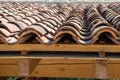 old canal tile roof with large wooden beam