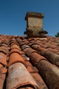 old canal tile roof with stone chimney