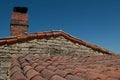 old canal tile roof with stone chimney