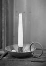 Old candle in a brass candlestick on a table Royalty Free Stock Photo