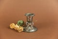 Old candle holder and yellow roses against a brown background. Melchior alloy candle holder. A branch of dried yellow flowers Royalty Free Stock Photo