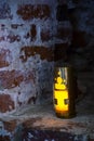 An old candle lamp in the niche on brick wall. Ancient candle lantern illuminates from the niche Royalty Free Stock Photo