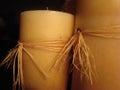 Old candles with corn husk ribbon