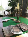 Old candlestick on the playing table with cards and money Royalty Free Stock Photo