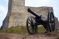 Old cannon on the background of a medieval castle. ChÃâ¢ciny, Poland. Royalty Free Stock Photo