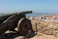 Old Cannon at Castelo de Sao Jorge, Aerial view of Lisbon and 25th April Bridge, Portugal. Royalty Free Stock Photo