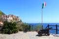 Old cannon, Italian flag and Cinque Terre village Manarola with colorful houses and Mediterranean Sea Royalty Free Stock Photo