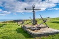 Old cannon and rusty anchor as tourist attraction in Wicklow port