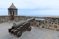 Old cannon and sentry box on the boardwalk at the entrance to the port in Puerto de la Cruz, Tenerife