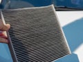 Old car air filter with dirty dust. Used carbon air conditioning in auto holding by hand. Royalty Free Stock Photo