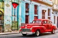 Old car and and building with the cuban flag in Old Havana Royalty Free Stock Photo