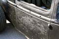Old car door is riddled with bullet holes Royalty Free Stock Photo