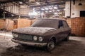 Old car with dust and dirt stuck in an abandoned building. Royalty Free Stock Photo