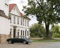 Old car in front of a mansion Royalty Free Stock Photo