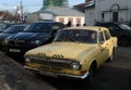 The old car GAZ-24 `Volga` taxi yellow is on the street Varvarka in Moscow. Royalty Free Stock Photo