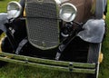 An old car`s grill and headlamps