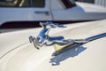 Close-up of shiny chrome plated deer on the hood of the classic soviet retro car GAZ-21 Volga