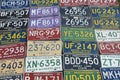 Collection of old American license plates from different states on the wall Royalty Free Stock Photo