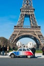 Old car next to Eiffel tower Royalty Free Stock Photo