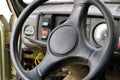 Old car panel dashboard of seventies vehicle with speedometer, and buttons of lights and fan, leather steering wheel, selective Royalty Free Stock Photo