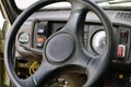 Old car panel dashboard of seventies vehicle with speedometer, and buttons of lights and fan, leather steering wheel, selective Royalty Free Stock Photo