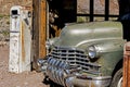 An old vintage rusted car sits in the landscape of Nevada.