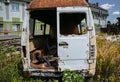 Old car standing in the field. Van after the crash. Dirty rusty seats. Abandoned bus Royalty Free Stock Photo