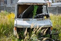 Old car standing in the field. Van after the crash. Dirty rusty seats. Abandoned bus Royalty Free Stock Photo