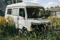 Old car standing in the field. Van after the crash. Dirty rusty seats. Abandoned bus Royalty Free Stock Photo